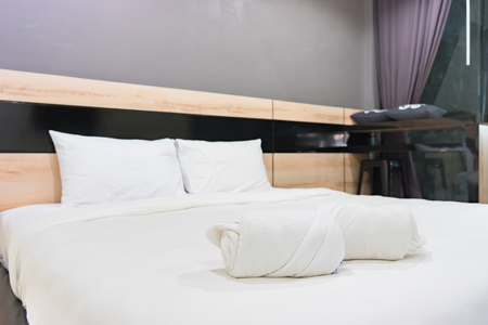 bedroom in soft light colors. big comfortable double bed in elegant classic bedroomの写真素材