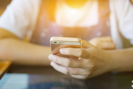 Online banking payment communication network technology internet wireless tools development mobile smartphone sync app: Business woman holding smart phone for online or shopping payment,vintage colorの写真素材