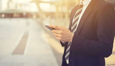 contact us,businessman working with modern devices, hipster man using digital tablet computer and mobile smart phone,business concept,selective focus,vintage colorの写真素材