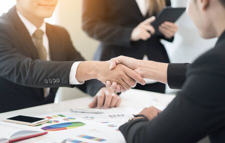 Business partnership marketing meeting concept. Image businessmans handshake. Successful businessmen handshaking after good deal.vintage color, Discussing Together Startup Idea.Working Online Projectの写真素材
