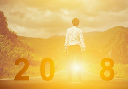 2018 years ,Silhouette businessman standing on the road while celebrating a happy new year, copy space.の写真素材