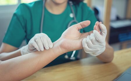 Doctor hand Physicist physical therapy treatment patient in the clinic.Orthopedic medical exam in...