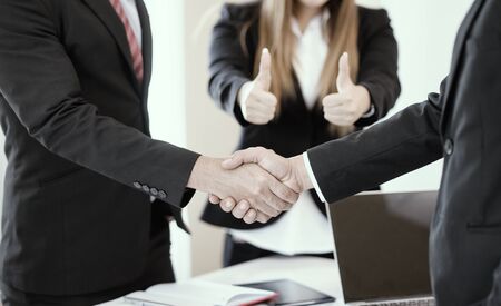 work together,Business partnership handshake concept.Photo two coworkers handshaking process.Successful deal after great meetingの写真素材