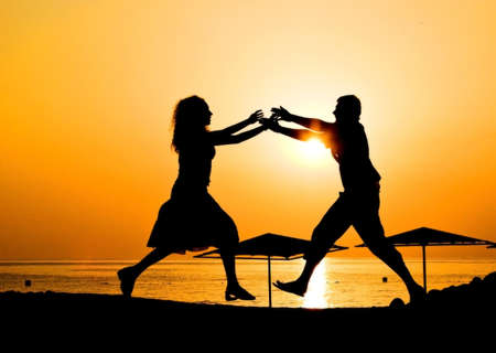 Male and female at sunrise at beach