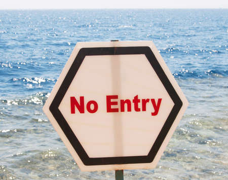 The sign prohibiting the entrance to the sea located on the beachの写真素材