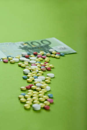 Pills and tablets with Euro bill on paperの写真素材