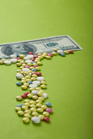 Pills and tablets with US paper currencyの写真素材