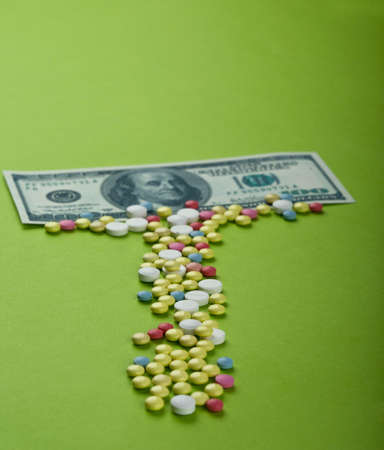 Pills and tablets with US paper currencyの写真素材