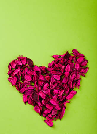 heart made ??of red rose petals on the paperの写真素材