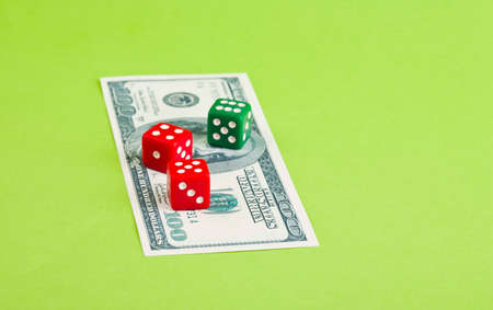 Three  dices on dollar  banknote on the paperの写真素材