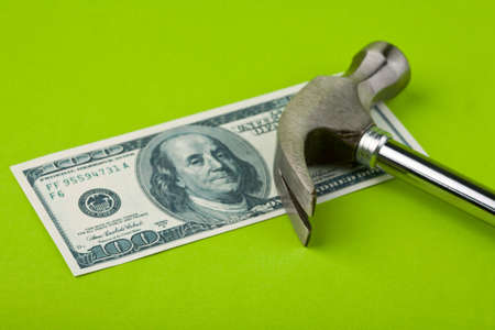 Hammer on top of dollar note to illustrate currency crisis in Europeの写真素材