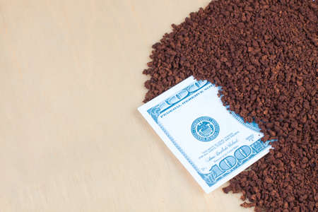 instant coffee on a wooden background  and dollarの写真素材