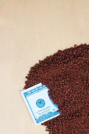 instant coffee on a wooden background  and dollarの写真素材