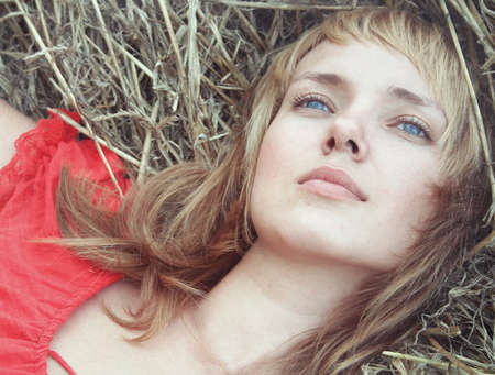 sad, beautiful young woman pining at natureの写真素材