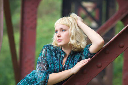 beautiful young caucasian girl is on bridge bearingの写真素材