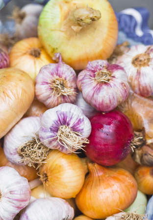 Many mature onions, different types of lies in a basketの写真素材