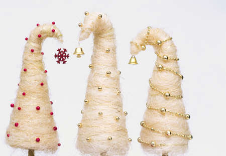 Shiny miniature Christmas trees made of sisal with beadsの写真素材