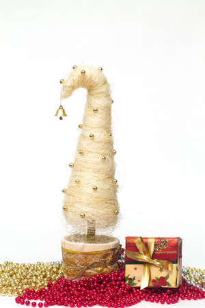 Shiny miniature Christmas tree made of sisal with beads and presentの写真素材