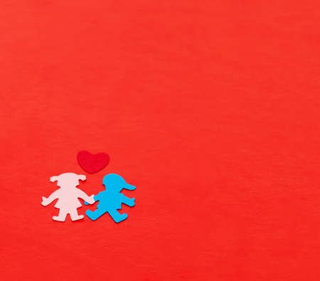 multicolored paper boy and girl with red paper hearth  on red paperの写真素材