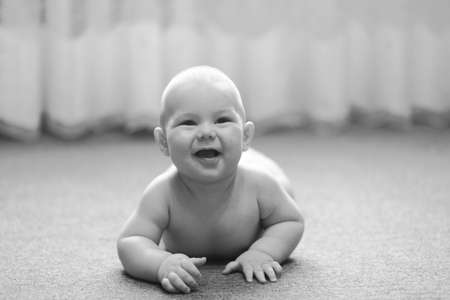 Baby boy crawling on the floor  inside the roomの写真素材