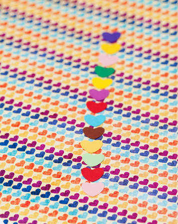 line of multicolored paper hearths  on multicolored paper