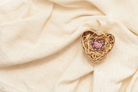 ring in cardboard box in the form of heart  on linen fabricの写真素材