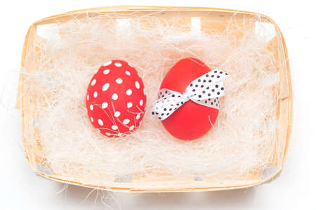 colorful easter eggs on braiding basket with sisalの写真素材