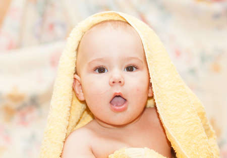 happy sweet baby in towelの写真素材