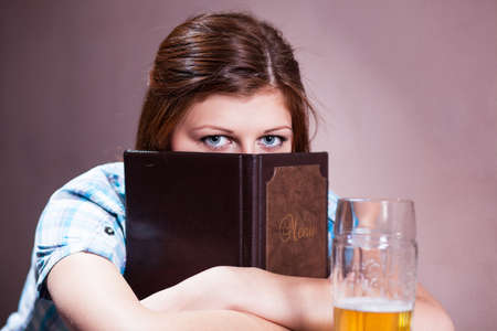 Pretty young lady ready to order at pub