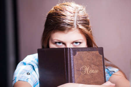 Pretty young lady ready to order at pubの写真素材