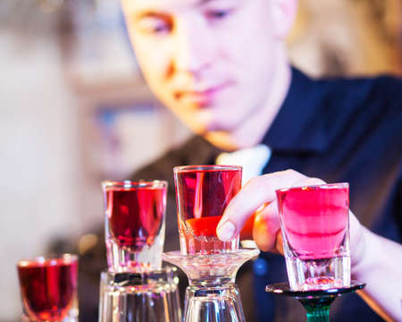 Young professional barman in action making cocktail drinksの写真素材