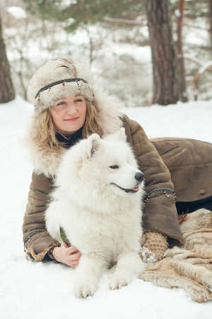 Portrait of a beautiful woman on winter parkの写真素材