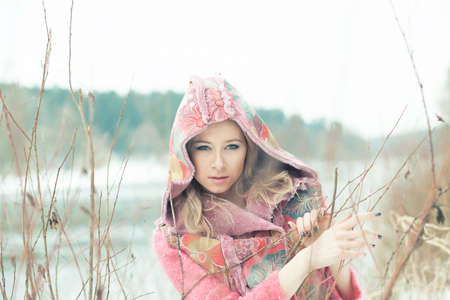 Portrait of a beautiful woman on winter parkの写真素材