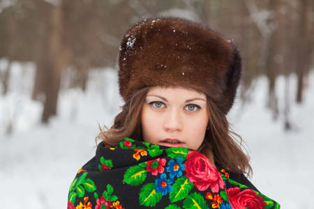 Portrait of a beautiful girl in a fur hatの写真素材