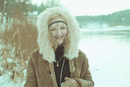 Portrait of a beautiful woman on winter parkの写真素材