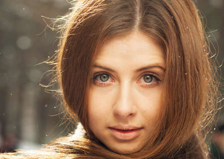 Portrait of a beautiful girl on winter parkの写真素材