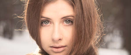 Portrait of a beautiful girl on winter parkの写真素材