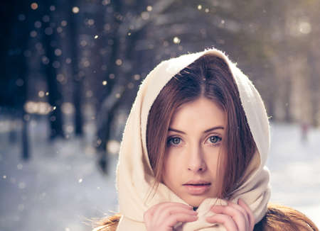 Portrait of a beautiful girl on winter parkの写真素材