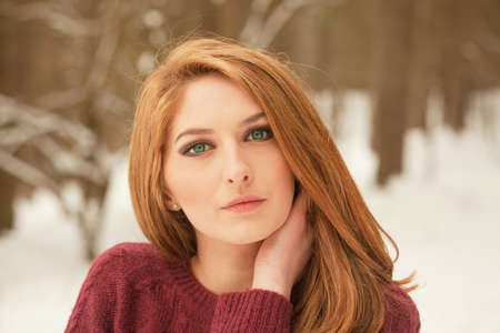 Portrait of a beautiful woman on winter park