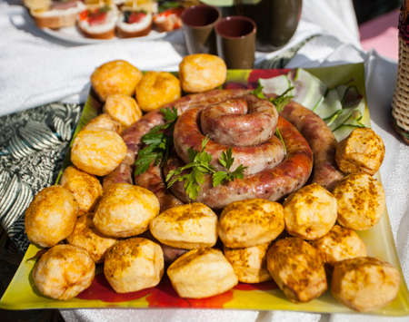 grilled meat sausages with potatoesの写真素材