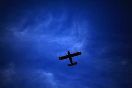 Retro-biplane aircraft, against the blue skyの写真素材