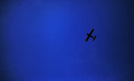 Retro-biplane aircraft, against the blue skyの写真素材