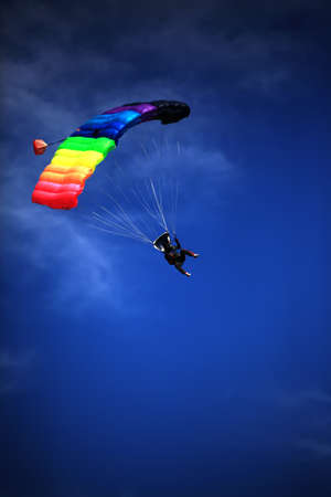 single parachute jumper against blue sky backgroundの写真素材
