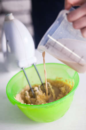 Mixing  egg cream in bowl with motor mixer, baking cakeの写真素材