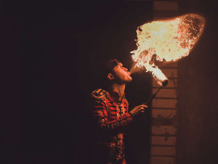 Fire show artist breathe fire in the darkの写真素材