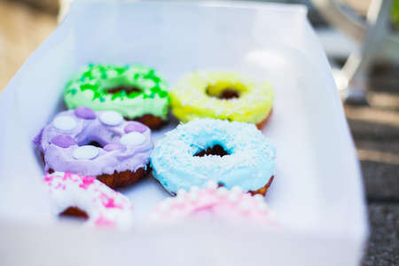 sweets and colorful donuts in boxの写真素材