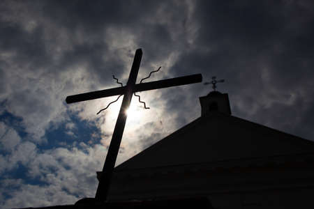 cross on a background of the sun and the church .の写真素材