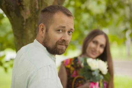 portrait of a man and woman with flowers in nature .
