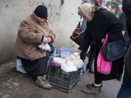 KUTAISI, GEORGIA - FEBRUARY 23, 2016: .Old woman farmer sells his cheese and eggs.のeditorial素材