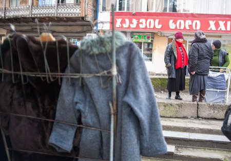KUTAISI, GEORGIA - FEBRUARY 23, 2016: women sell clothes in a street market.のeditorial素材